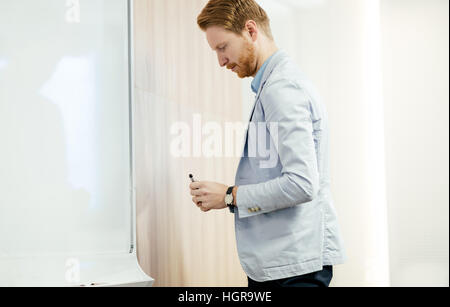 Businessman using whiteboard to present future plans Stock Photo