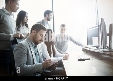 Group of business people and software developers working as a team in office Stock Photo
