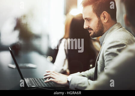 Programmer working and developing software  in office on laptop Stock Photo