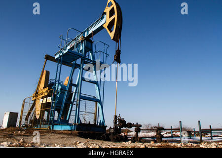 Bucharest, Romania, December 30, 2012: Slate gas or oil derrick pumps natural gas from underground on a field outskirts Bucharest. Stock Photo