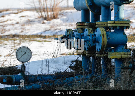 Bucharest, Romania, December 30, 2012: Slate gas or oil equipment with many pipelines, valves, connectors, panel and motors are seen on a field outski Stock Photo