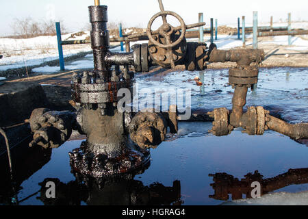 Bucharest, Romania, December 30, 2012: Slate gas and oil equipment with many pipelines, valves, connectors, panel and motors are seen on a field outsk Stock Photo