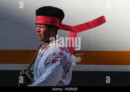 Bucharest, Romania, December 30, 2012: A man dressed in national costumes and wearing a whip is performing in a tram station in Bucharest. Stock Photo