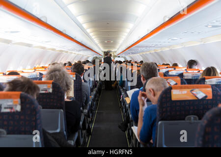 The cabin aisle on an Easyjey Airbus A320 passenger plane / airplane / aeroplane / air plane during flight. Stock Photo