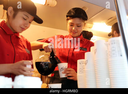 Tokyo, Japan. 12th Jan, 2017. McDonald's Japan employees prepare free sample coffee at a promotional event for McDonald's new coffee in Tokyo on Thursday, January 12, 2017. The hamburger restaurant chain will launch the new taste coffee at their restaurants from January 16. © Yoshio Tsunoda/AFLO/Alamy Live News Stock Photo