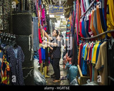 Bangkok, Thailand. 12th Jan, 2017. A woman shops for clothes in Bo Bae Market. Bo Bae Market is a sprawling wholesale clothing market in Bangkok. There are reportedly more than 1,200 stalls selling clothes made in Thailand and neighboring countries. Bangkok officials have threatened to shut down parts of Bo Bae market, but so far it has escaped the fate of the other street markets that have been shut down. © Jack Kurtz/ZUMA Wire/Alamy Live News Stock Photo