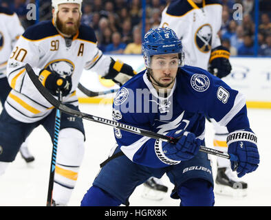 Tampa Bay Lightning center Tyler Johnson (9, right) watches his wrist ...