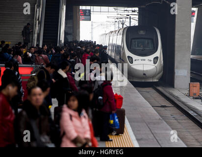 Wuhan, China's Hubei Province. 13th Jan, 2017. Passengers wait to board on the platform of Hankou Railway Station in Wuhan, capital of central China's Hubei Province, Jan. 13, 2017. About 2.98 billion trips are expected to be made during China's 2017 Spring Festival travel rush between Jan. 13 and Feb. 21. The figure represents an increase of 2.2 percent from the same period in 2016. The Spring Festival, or Chinese Lunar New Year, falls on Jan. 28 this year. The festival is the most important occasion for family reunions. © Xiao Yijiu/Xinhua/Alamy Live News Stock Photo