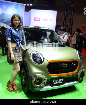 Tokyo, Japan. 13th Jan, 2017. A model poses beside a vehicle at the Tokyo Auto Salon 2017 in Chiba, Japan, on Jan. 13, 2017. The exhibition showcases the latest customized cars and car-related products. © Ma Ping/Xinhua/Alamy Live News Stock Photo