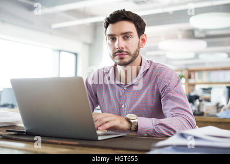 Male architect working with laptop in the office Stock Photo