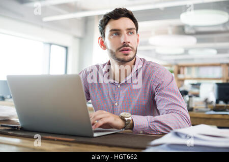 Male architect working with laptop in the office Stock Photo