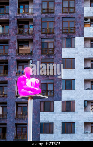 Illuminated man sculpture on a pole in front of a building seen from Yerevan Cascade, Armenia, Middle East, Asia Stock Photo