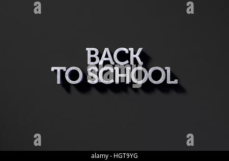 A 3D render of metal extruded text spelling out the phrase back to school on classy black background Stock Photo