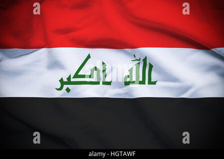 Wavy and rippled national flag of Iraq background. Stock Photo