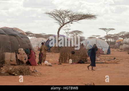 Somalian living in makeshift shelters at the Dadaab refugee camp on the border of Somalia and Kenya. Stock Photo