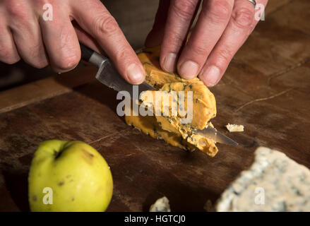 A cheese expert sampling a slice of Shropshire Blue UK Stock Photo