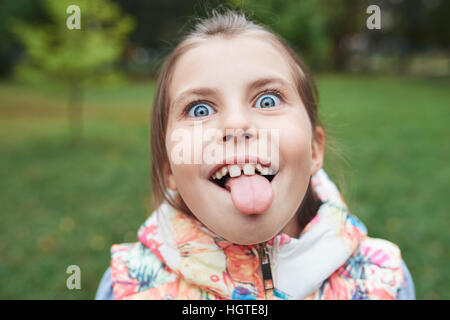 Cute little girl sticking out her tongue Stock Photo