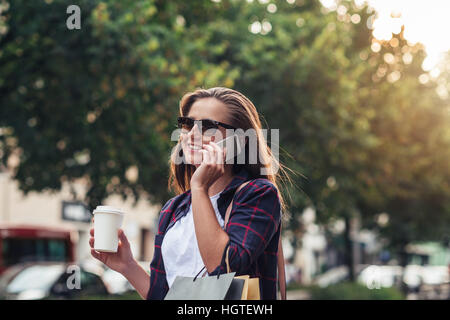 Young woman talking on her cellphone while shopping Stock Photo