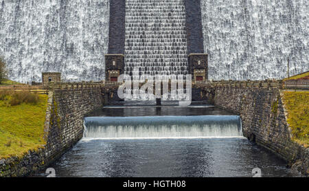 The base of the Claerwen Dam at the top of the Claerwen Valley in Mid Wales with water cascading down Stock Photo