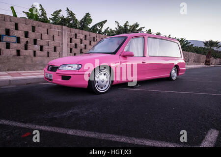 Pink Vauxhall Omega hearse with UK registration being used as a campervan, parked on a side road in Playa San Juan, Tenerife, Stock Photo