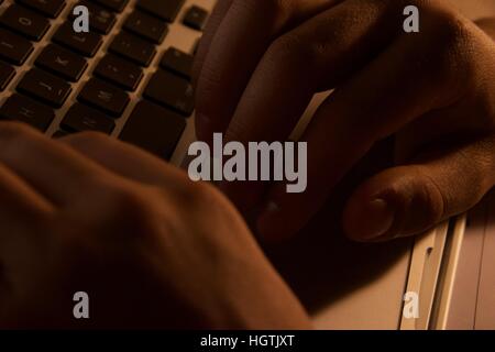 Late night study sessions, closeup picture on hands typing on keyboard Stock Photo