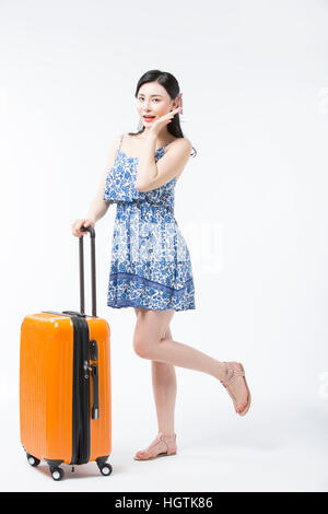 Young woman in summer dress posing with a carrier Stock Photo