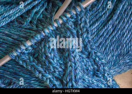 Hand knitted piece of cable fabric. Stock Photo