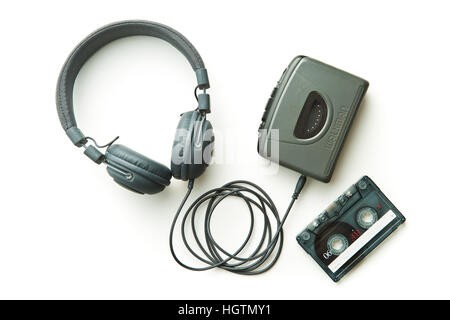 Vintage walkman, audio tape and headphones isolated on white background. Stock Photo