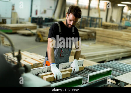 Handsome young man working in the furniture factory Stock Photo