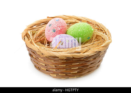 Easter eggs in basket isolated on white Stock Photo