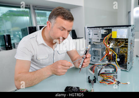 technician fixing computer part Stock Photo