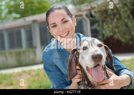 shelter keeper loves her residents Stock Photo