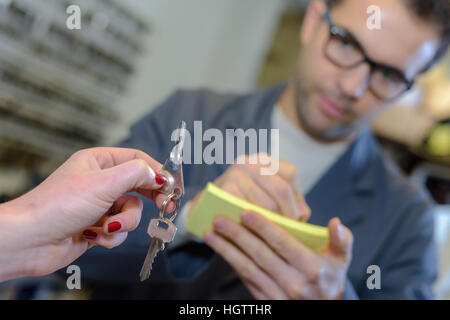 Customer handing over keys Stock Photo