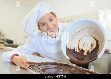 pouring chocolate to bake