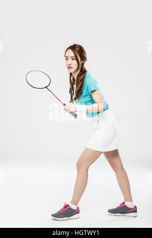 Young smiling female badminton player posing Stock Photo