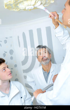 Apprentice painting ceiling rose Stock Photo