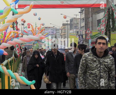 Iranian people march in Tehran streets at Islamic Revolution anniversary rally, national day of Iran - street level Stock Photo