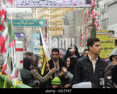 Iranian people march at Islamic Revolution anniversary rally, national day of Iran in Tehran streets - street level Stock Photo