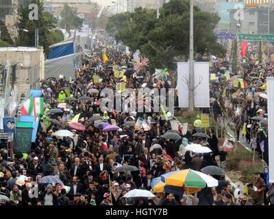 Large crowds of Iranian people marching for Islamic Revolution anniversary rally, national day of Iran, in Tehran streets Stock Photo