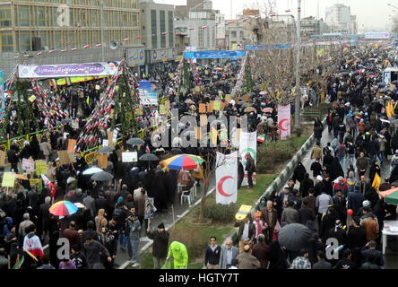 March of large crowds of Iranian people for Islamic Revolution anniversary rally, national day of Iran in Tehran streets Stock Photo