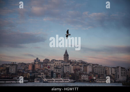 The sun sets behind Galata Tower in Istanbul. Stock Photo