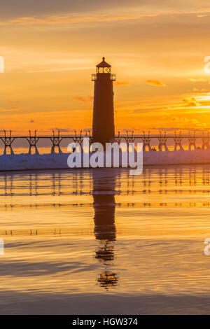 Grand Haven Lighthouse at sunset, at the mouth of the Grand River where it enters Lake Michigan, Grand Haven, Michigan, USA Stock Photo