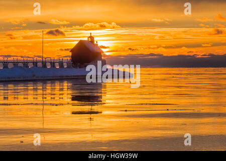 Grand Haven Lighthouse at sunset, at the mouth of the Grand River where it enters Lake Michigan, Grand Haven, Michigan, USA Stock Photo