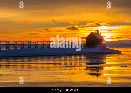 Grand Haven Lighthouse at sunset, at the mouth of the Grand River where it enters Lake Michigan, Grand Haven, Michigan, USA Stock Photo