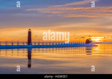 Grand Haven Lighthouse at sunset, at the mouth of the Grand River where it enters Lake Michigan, Grand Haven, Michigan, USA Stock Photo