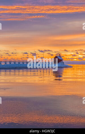 Grand Haven Lighthouse at sunset, at the mouth of the Grand River where it enters Lake Michigan, Grand Haven, Michigan, USA Stock Photo