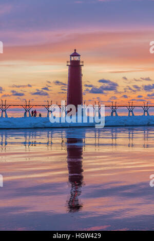 Grand Haven Lighthouse at sunset, at the mouth of the Grand River where it enters Lake Michigan, Grand Haven, Michigan, USA Stock Photo