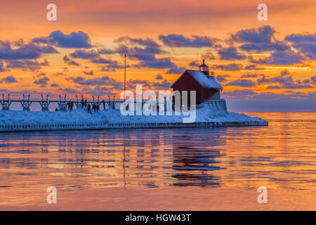 Grand Haven Lighthouse at sunset, at the mouth of the Grand River where it enters Lake Michigan, Grand Haven, Michigan, USA Stock Photo