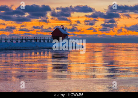 Grand Haven Lighthouse at sunset, at the mouth of the Grand River where it enters Lake Michigan, Grand Haven, Michigan, USA Stock Photo