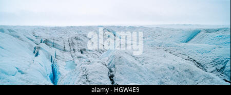 The frozen and barren wasteland of ice and crevasse on the surface of the Greenland Ice Sheet. Stock Photo